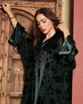 green velvet abaya adorned with raised circular patterns
